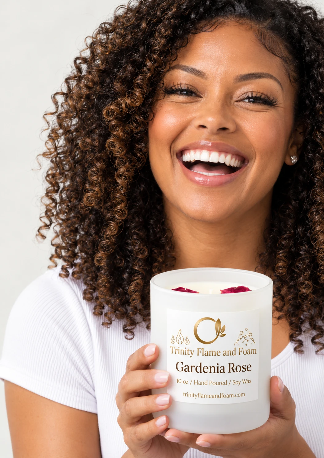 Woman smiling while holding a hand-poured wickless soy candle